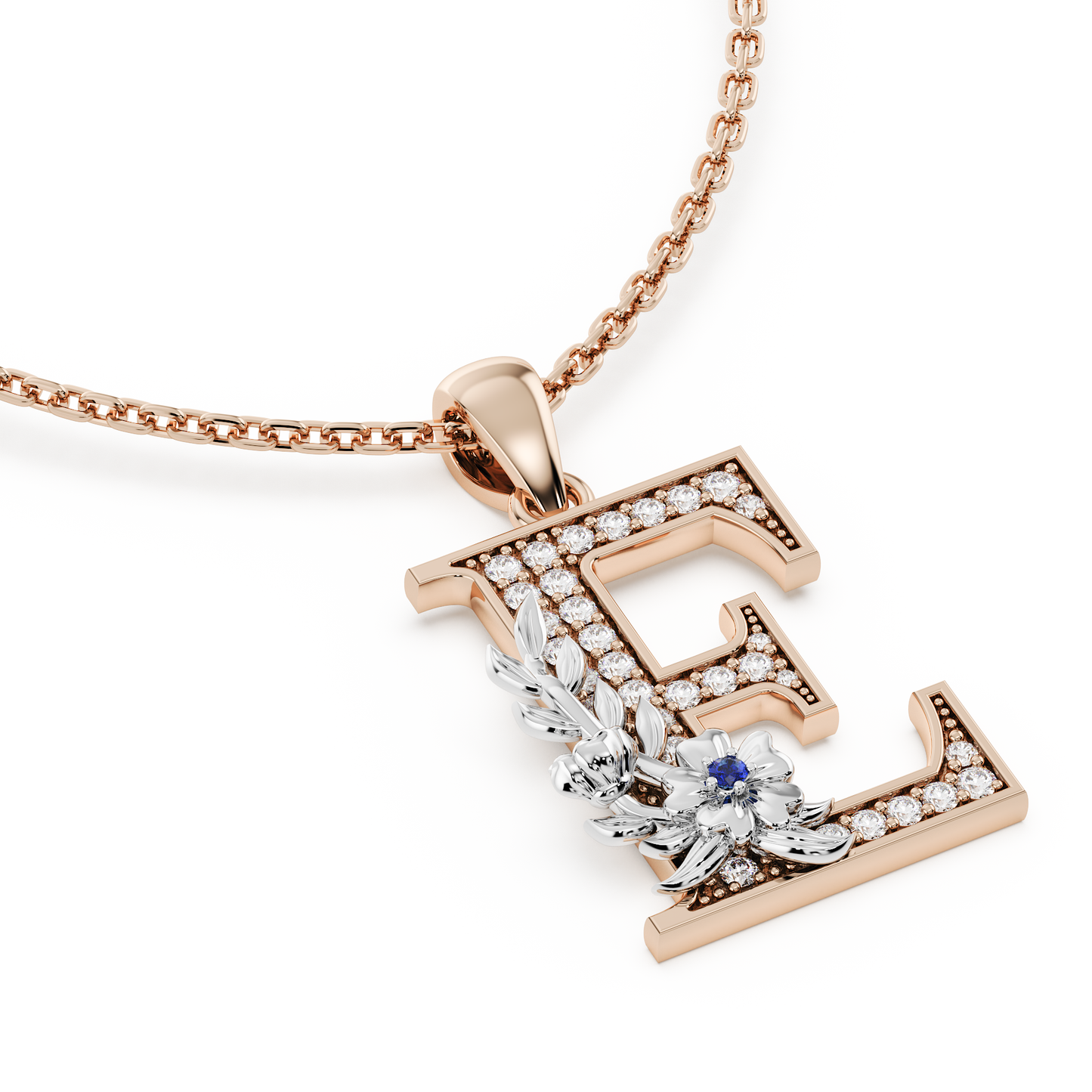 Handcrafted white gold letter E initial pendant from the Everbloom collection, set with diamonds and a rose gold floral motif featuring a round Blue sapphire gemstone.
