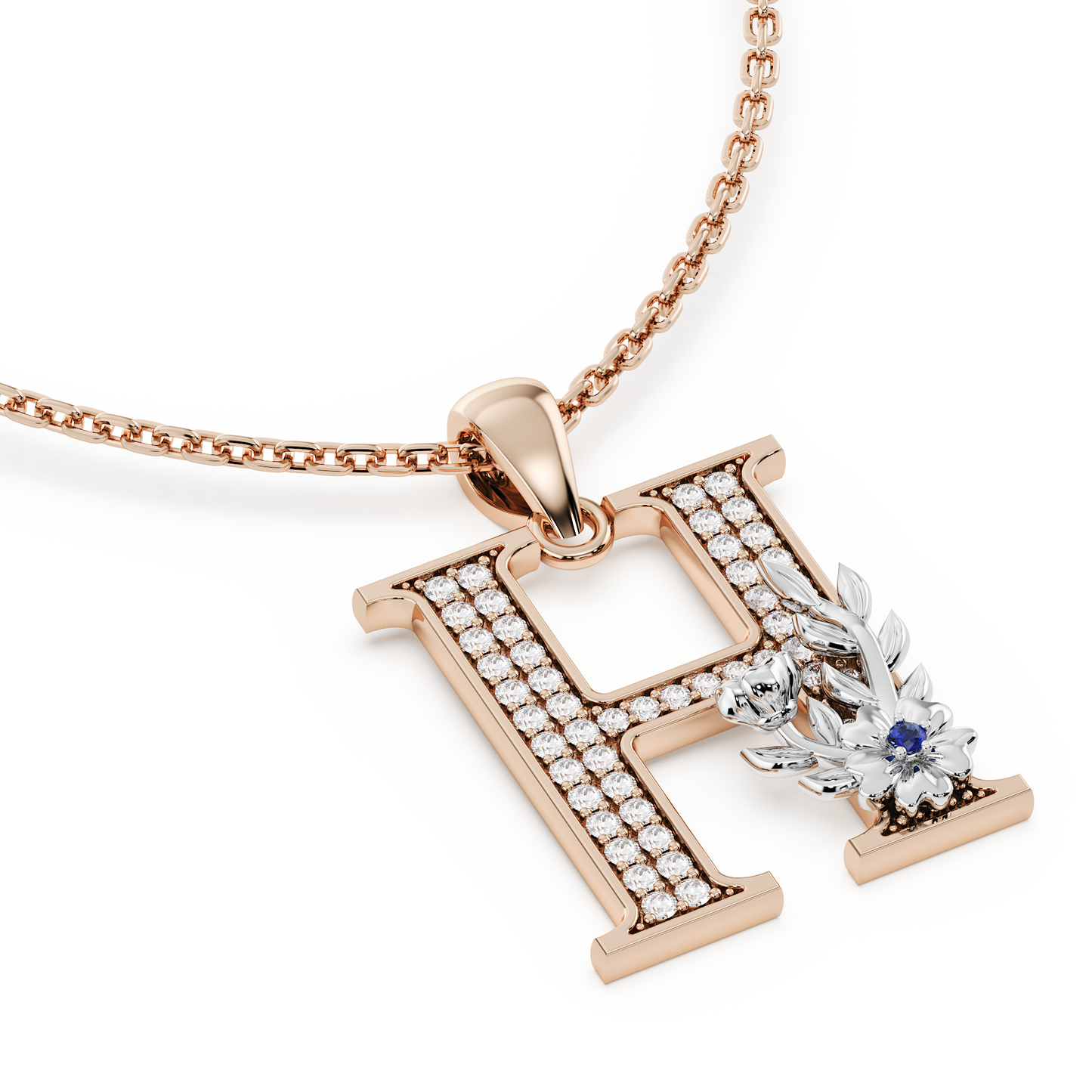 Handcrafted white gold letter H initial pendant from the Everbloom collection, set with diamonds and a rose gold floral motif featuring a round Blue sapphire gemstone.