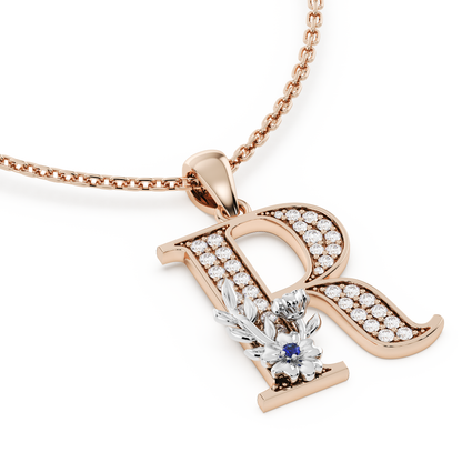 Handcrafted white gold letter R initial pendant from the Everbloom collection, set with diamonds and a rose gold floral motif featuring a round Blue sapphire gemstone.