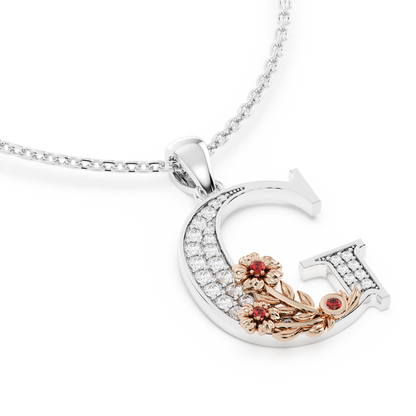 Handcrafted white gold letter G initial pendant from the Everbloom collection, set with diamonds and a rose gold floral motif featuring a round Ruby gemstone.
