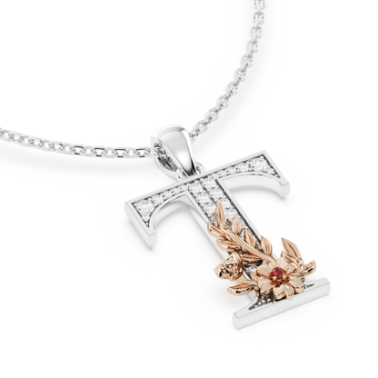 Handcrafted white gold letter T initial pendant from the Everbloom collection, set with diamonds and a rose gold floral motif featuring a round Ruby gemstone.